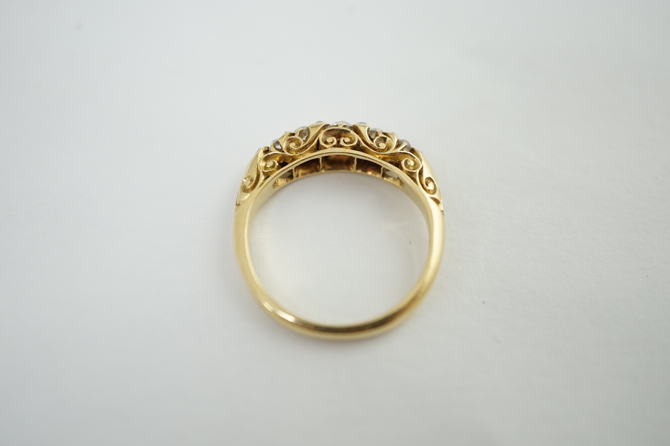 A late Victorian 18ct gold and graduated seven stone diamond set half hoop ring